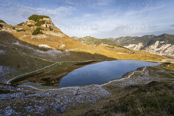 Lake Augstsee and the Atterkogel mountain on the Loser. Autumn, good weather, blue sky. Golden hour