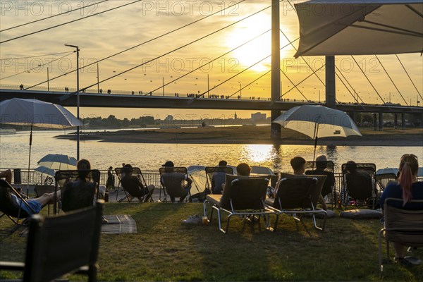The city beach on the Rhine near Düsseldorf, riverside promenade, by the Rheinkniebrücke bridge,