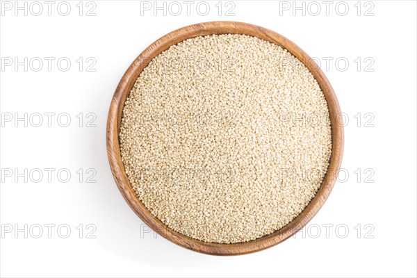 Wooden bowl with raw white quinoa seeds isolated on white background. Top view, flat lay