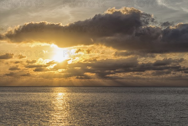 Beautiful sunset over the sea with the sun rays through the clouds, Malaysia, Asia