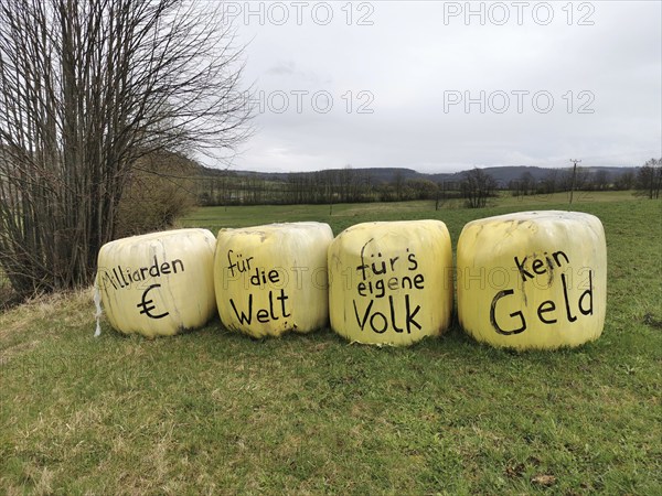 Billions of euros for the world, no money for our own people, farmers protest on bales of grass