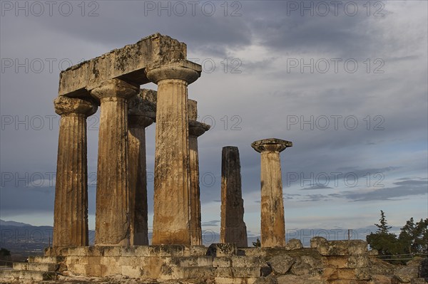 Archaic Temple of Apollo, Doric Columns, Ancient Greek columns stand tall under a dramatic evening
