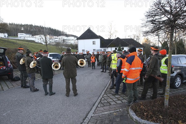Hunters and hunting assistants, so-called beaters, in front of the start of the hunt, address by