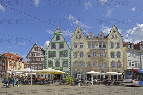 Historic restaurant Hofbräu am Dom with green tail gable, houses and tram, green, street