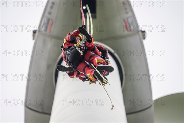 Height rescuers from the Gelsenkirchen fire brigade practise abseiling from a wind turbine from a