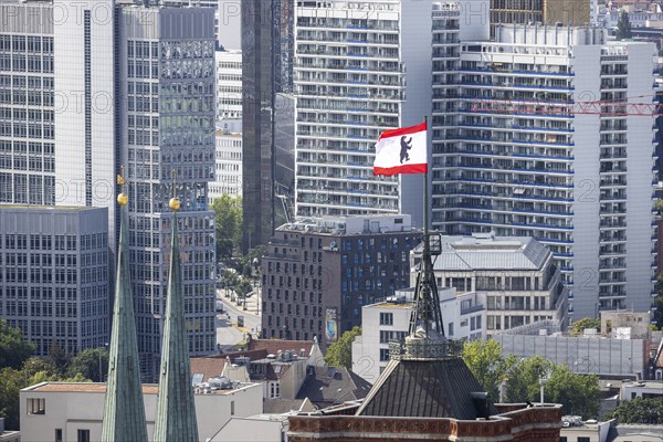 City view. View of the spires of the Rotes Rathaus and the Nikolaikirche. Flag with Berlin bear,