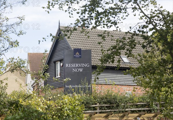 New houses modern property development, Hopkins Homes 'Reserving Now' sign, Saxmundham, Suffolk,