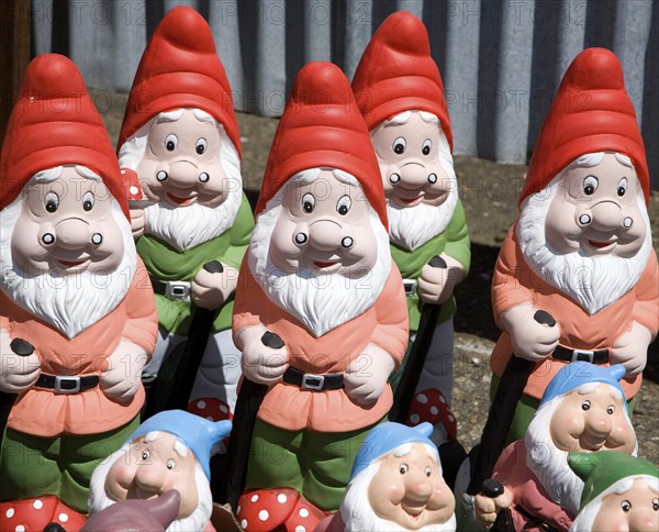 Colourful garden gnomes lined up for sale, UK