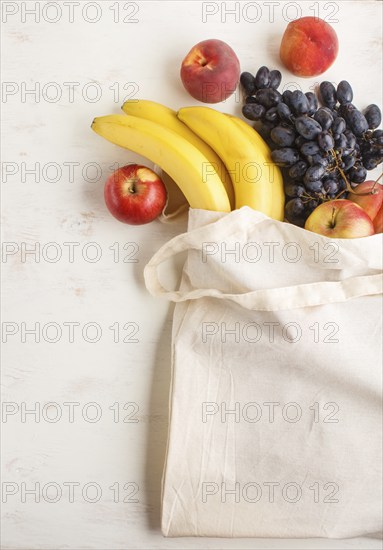 Fruits in reusable cotton textile white bag. Zero waste shopping, storage and recycling concept,