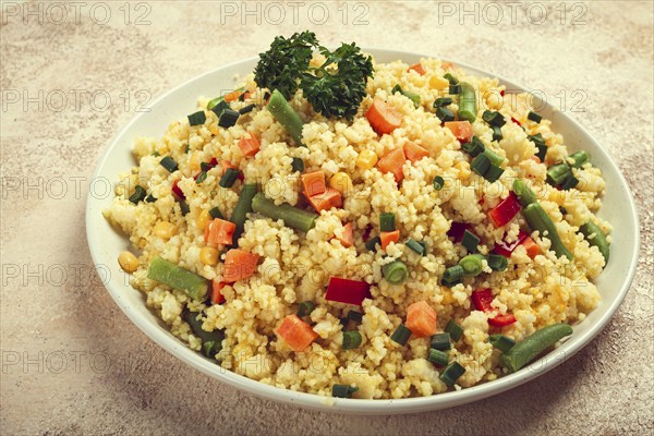 Couscous with vegetables, paprika, carrots, string beans, corn, homemade, top view, no people