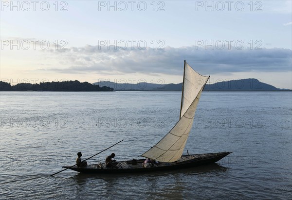 Fishermen paddle down the Brahmaputra River after fish in Guwahati, Assam, India on August 25, 2019