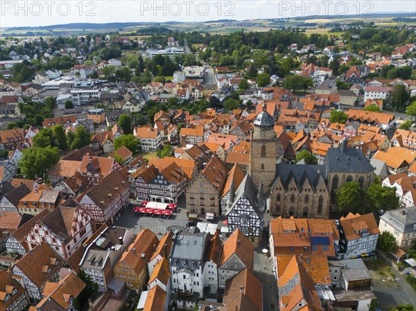 Aerial view of a picturesque historic town centre with many half-timbered houses and a large