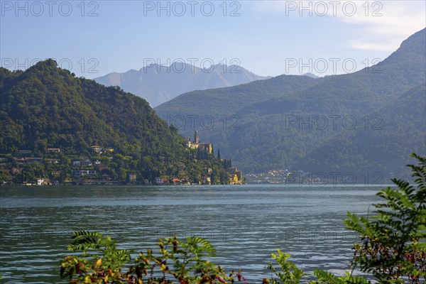 Church Santa Maria del Sasso with Trees Branches on the Mountain Side and Lake Lugano in Morcote,