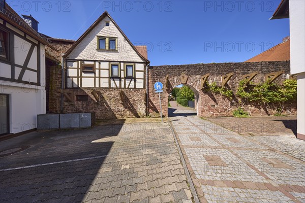 Historic town fortification with town gate under a cloudless blue sky at the Untere Pfarrgasse in