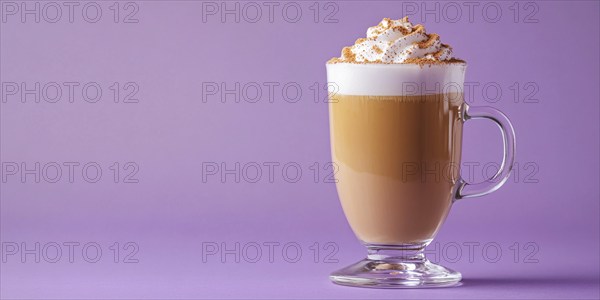 Banner with glass with seasonal pumpkin spice latte on violet background with copy space.