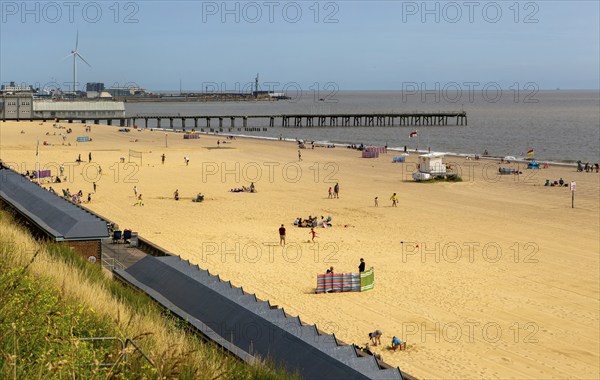 View over roofs of beach huts to Claremont Pier, South Beach, Lowestoft, Suffolk, England, UK