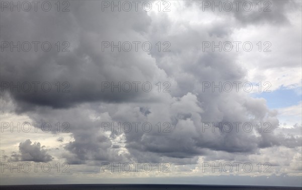 Heavy dark rain clouds pass over the land