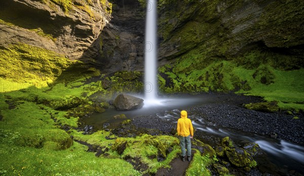 Tourist at Kvernufoss waterfall, in summer when the weather is fine, gorge and river, Skogar,