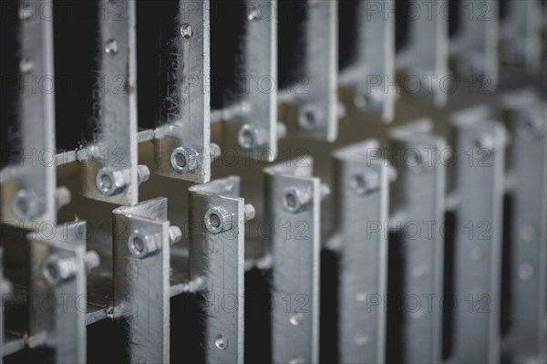 Finished galvanised steel parts lie in the factory hall of the surface finishing company Coatinc
