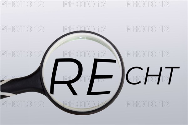Symbolic image for law, jurisdiction and justice: a magnifying glass over the written word law
