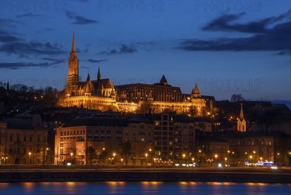 Royal Palace or the Buda Castle at sunset with lights illuminated at in danube river. Budapest