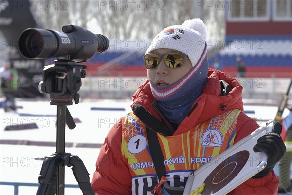 Coach of South Korea biathlon team instructs biathletes at shooting range of biathlon stadium