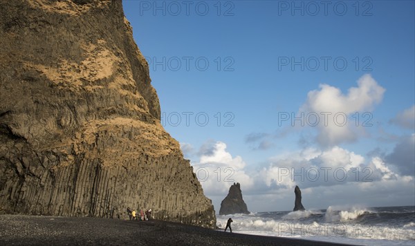 Unrecognised people sightseeing at reynisfjara black sand beach in Vik I mydral south Iceland.