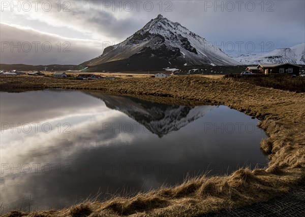 Mountain landscape at and hilltop reflection at a lake. Arnarstapi area in Snaefellsnes peninsula
