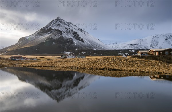Mountain landscape at and hilltop reflection at a lake. Arnarstapi area in Snaefellsnes peninsula