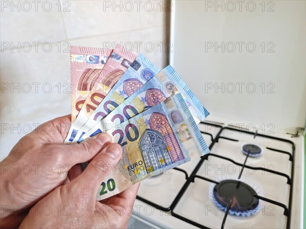 Energy efficiency concept with gas cooker and euro currency – the cost of natural gas is more