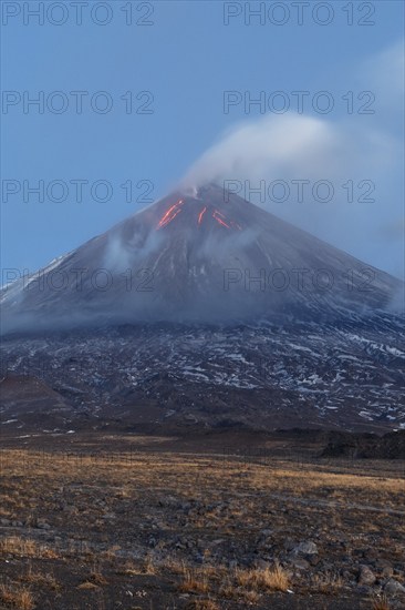 Volcanic landscape of Kamchatka: eruption Klyuchevskoy Volcano, lava flows on slope of volcano,