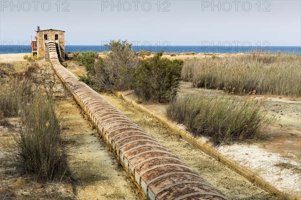 Abandoned old mining building and infrastructure to transfer the ore to ships sea for shipping at