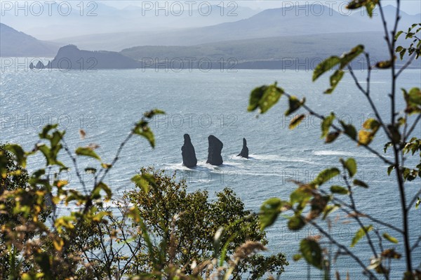 Stunning Kamchatka Peninsula seascape: top view of rocky mountain peak islands in sea, Three