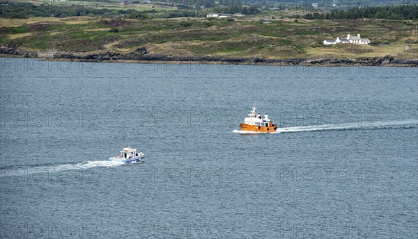 Small fishing boat sailing in Atlantic sea. Leisure activity, for whale watching, sport and