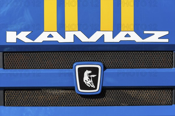 KAMCHATKA, RUSSIA, OCT 2, 2018: Badge and logotype of truck KAMAZ and sticker orange-blue stripes