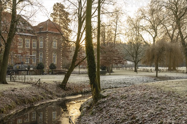 Winter river landscape at sunset with historic building, Velen, North Rhine-Westphalia, Germany,