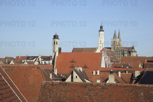 Townscape with spire of St. Johannis church, white town hall tower, half-timbered house