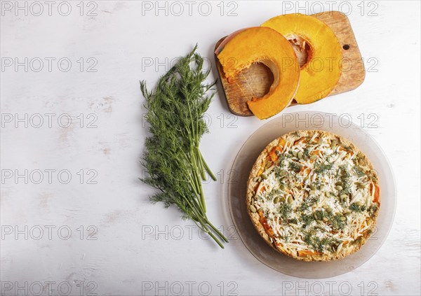 Sweet pumpkin pie with cheese and dill on white wooden background. top view. copy space