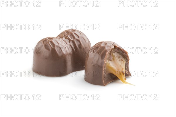 Chocolate caramel candies isolated on white background. Side view, close up