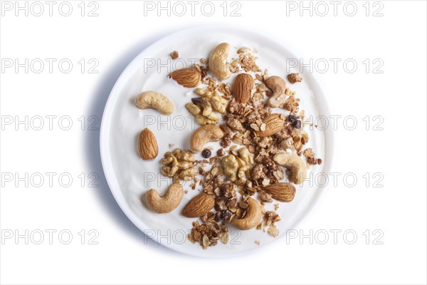 White plate with greek yogurt granola, almond, cashew, walnuts isolated on white background. top