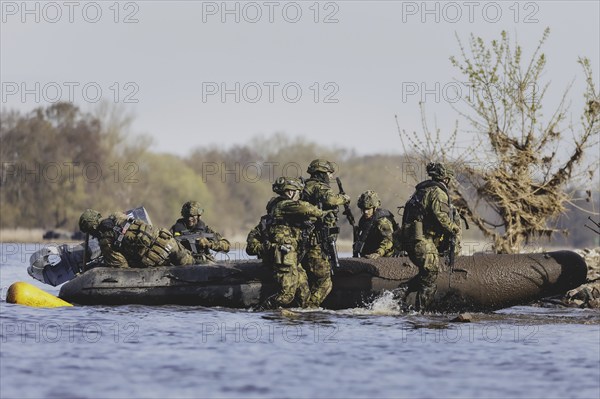 Czech and German soldiers launch an inflatable boat into the Elbe as part of the military exercise