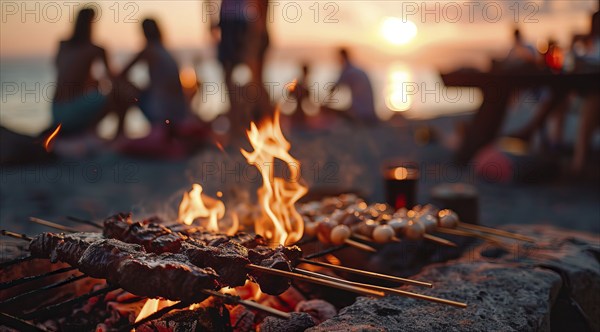 Barbecue BBQ family picnic party on the beach with skewers of meat and meat steaks over charcoal,
