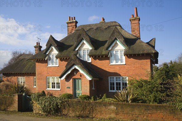 Red brick thatched building formerly the Chequers village pub, Sudbourne, Suffolk, England, United