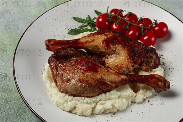 Fried duck shank, cauliflower puree, cherry tomatoes, homemade, no people