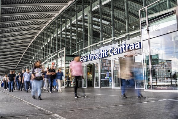 Station forecourt of Utrecht Centraal station, people on their way to, from the station,