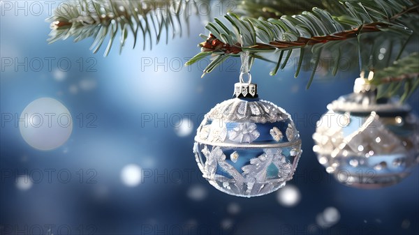 Set of Christmas ornaments hanging on a snow-covered pine tree branch, with frost clinging to the