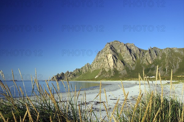 Island in the sea with calm sandy beach and blue sky with clouds, Bleik, Vesteralen, Langoya,