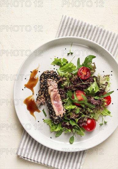 Vegetable salad, with fried tuna, in sesame seeds, healthy food, top view