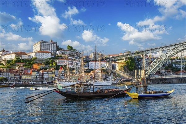 View of Porto city and Douro river with traditional boats with port wine barrels and sailing ship
