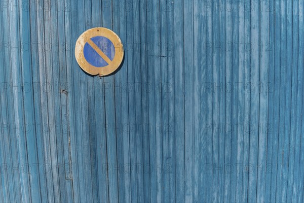 Garage door boards stained blue with worn paint. Brittany France